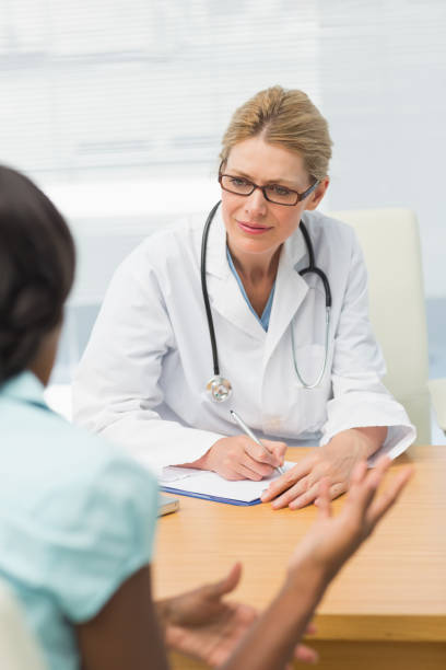 istock Concerned doctor listening to her patient and taking notes 835926318