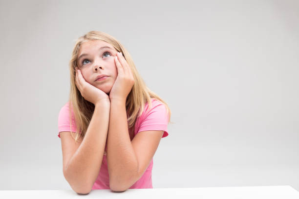 intelligent serious girl daydreaming or having a great idea that will change the world