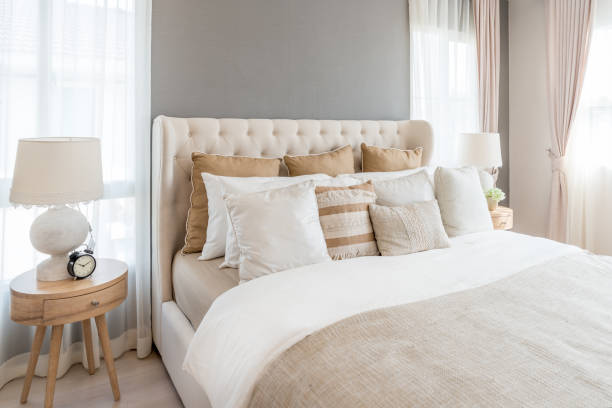bedroom in soft light colors. big comfortable double bed in elegant classic bedroom at home. - contemporary bed luxury hotel room imagens e fotografias de stock