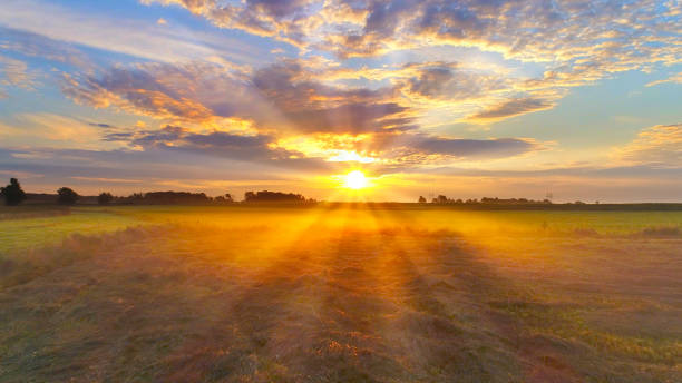 Amazing sunrise bursts through clouds over foggy Midwest farm fields