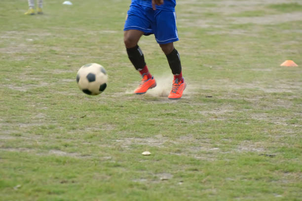 istock Soccer player kick ball 835934828