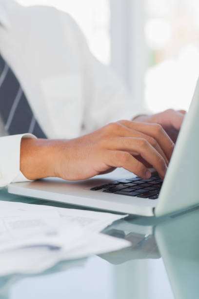 istock Close up on businessmans hands typing 835934952