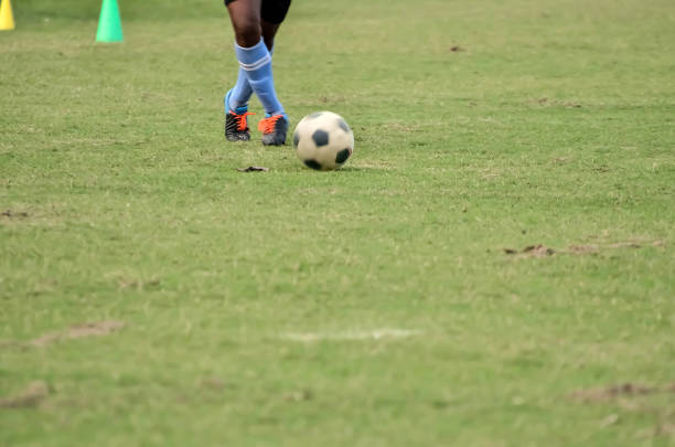 Soccer player is running to kick ball
