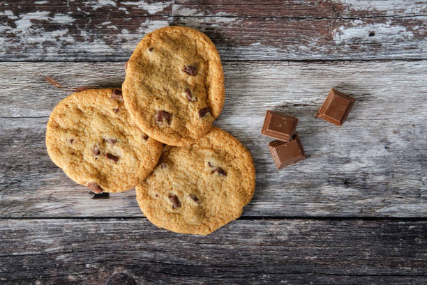 istock Fresh, home-made giant chocolate chip cookies seen on a rustic, wooden surface within a kitchen. 835935204