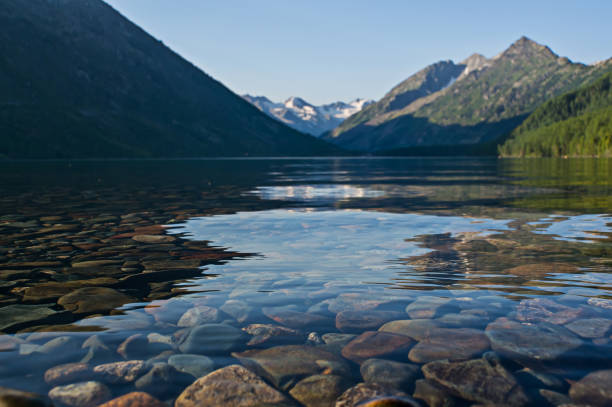 Mountain lakes filled with clean water from melting snow pack fill the wilderness scenery. Multinskoe lake mend the Altai mountains Siberia Russia