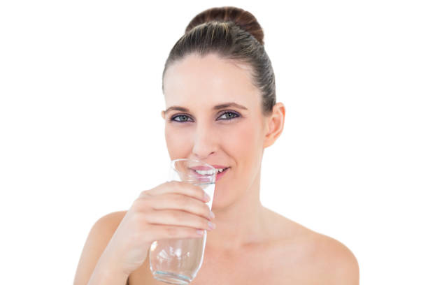 istock Woman drinking water looking at camera 835940774