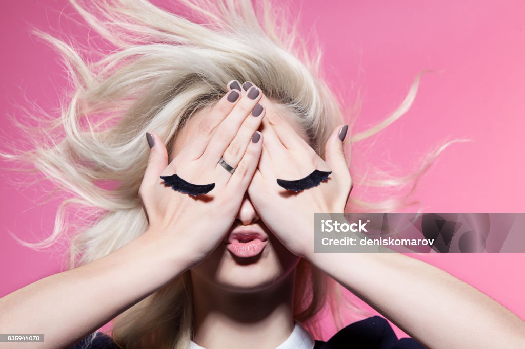 Girl with closed eyes painted on hands Eyelash Stock Photo