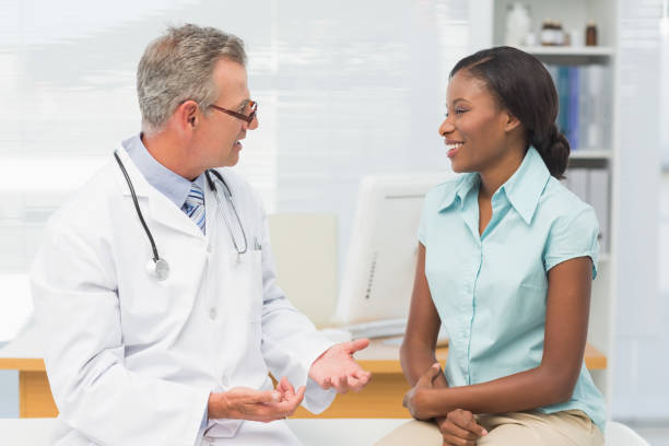 istock Doctor speaking with cheerful young patient 835947174