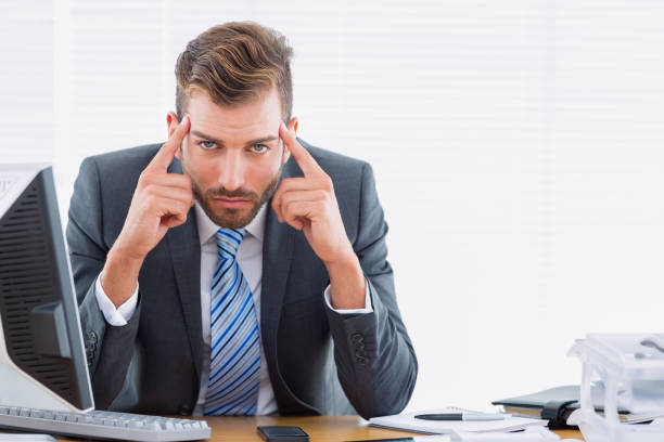 istock Elegant businessman with headache at office desk 835949768