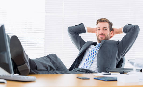 istock Relaxed confident businessman sitting with legs on desk 835949856