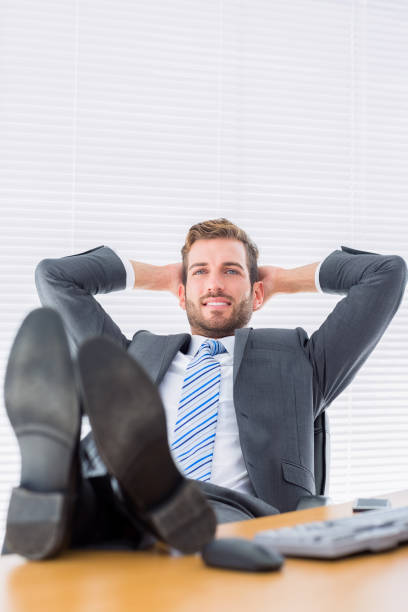 istock Relaxed businessman sitting with legs on desk 835949952