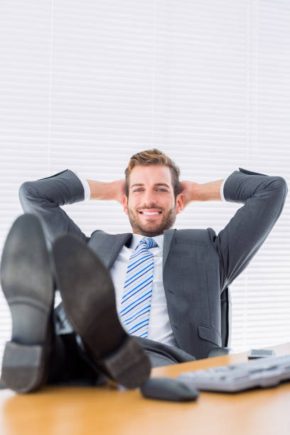 istock Relaxed businessman sitting with legs on desk 835949976