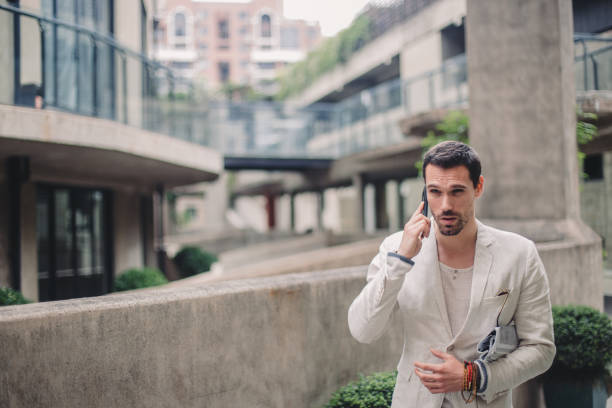 istock Stylish young businessman talking on the phone 835961126