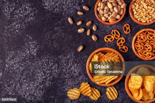 Snacks In A Bowls On Stone Background Stock Photo - Download Image Now - Appetizer, Backgrounds, Crunchy