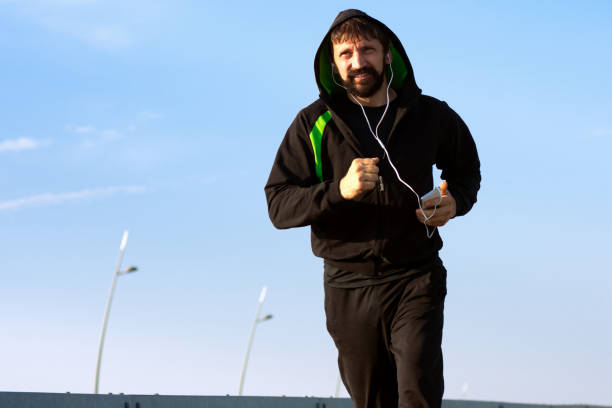 istock jogging with earphones 835987124