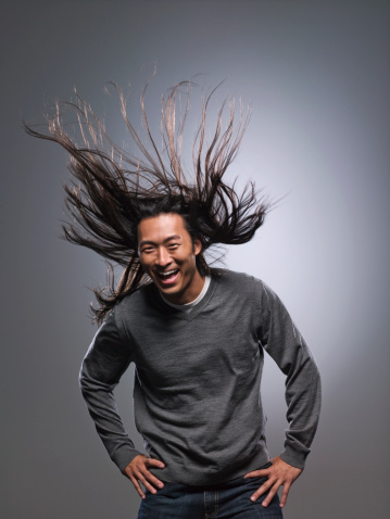 Man laughing, hair blowing in wind