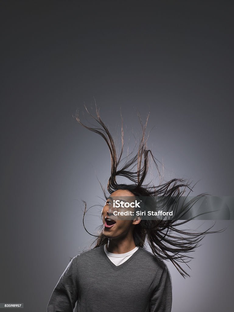 Man with long hair blowing in wind Tousled Hair Stock Photo