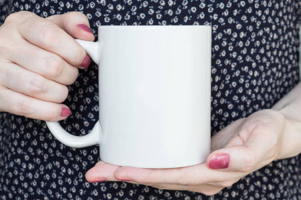 istock Girl is holding white cup in hands. 835994376