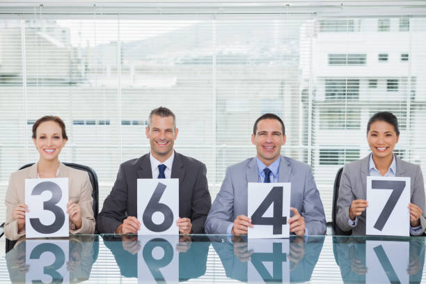 istock Smiling interview panel holding papers giving grade to their applicant 835998438