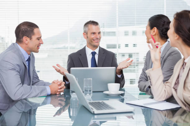 istock Smiling business people working together over coffee 835998542