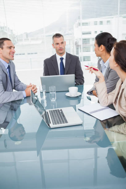 istock Concentrated business people working together over coffee 835998562