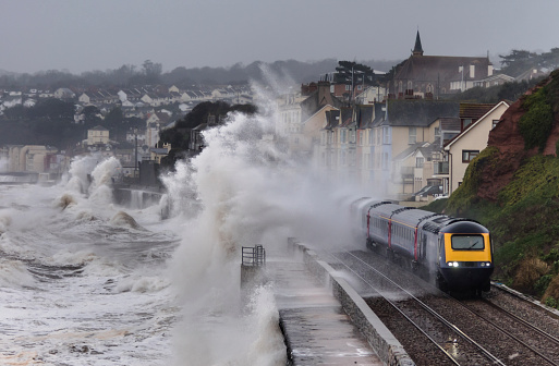 This intercity train is leaving Dawlish station in south Devon and heading for Exeter. A storm is in progress with a high tide and southerly winds which means the sea wall is getting a battering and trains are getting a soaking. This is also the spot where the main line was badly damaged in a severe storm February 2014