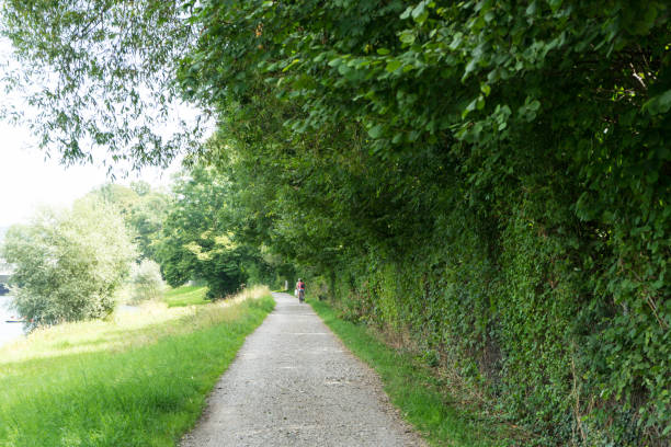 istock people riding bike next to river 836005028