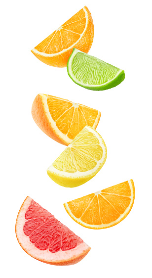 Isolated citrus fruits wedges. Falling pieces of orange, lemon, lime and grapefruit isolated on white background with clipping path