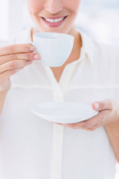 istock Mid section of a businesswoman with tea cup 836012088