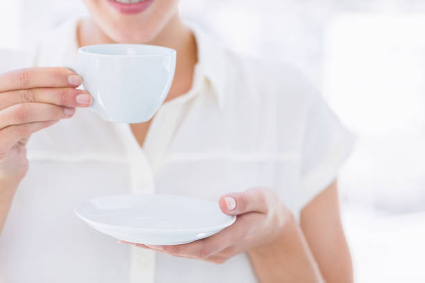 istock Mid section of a businesswoman with tea cup 836012096