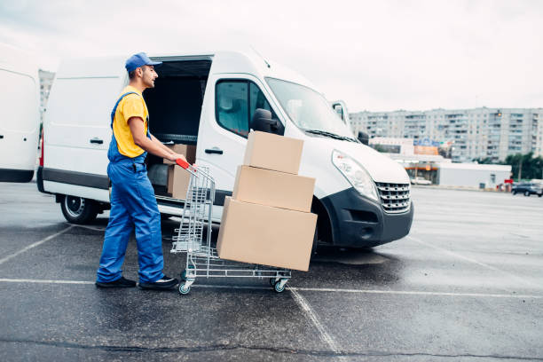 istock Courier with parcel trolley against logistic truck 836012114