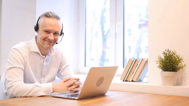 istock Smiling Middle Age Man at Work with Headphones 836020326