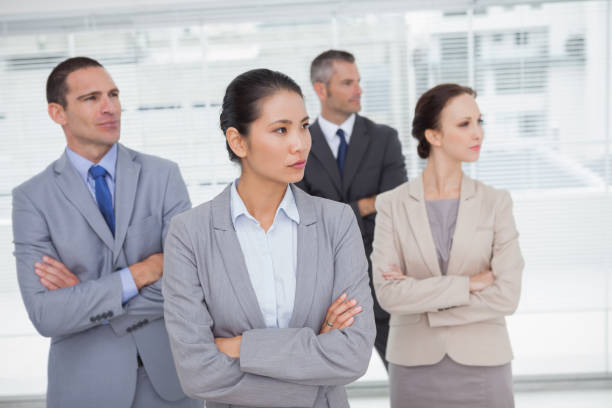 istock Stern work team crossing arms and looking away 836030264