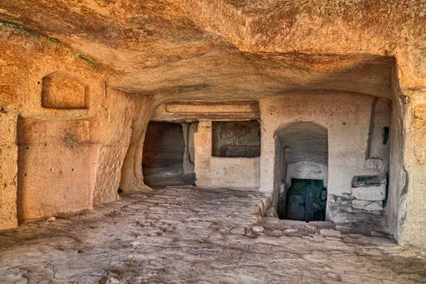 Matera, Basilicata, Italy: interior of an old cave house carved into the tufa rock in the old town (sassi di Matera)