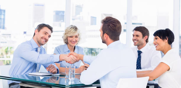 istock Executives shaking hands during business meeting 836041748