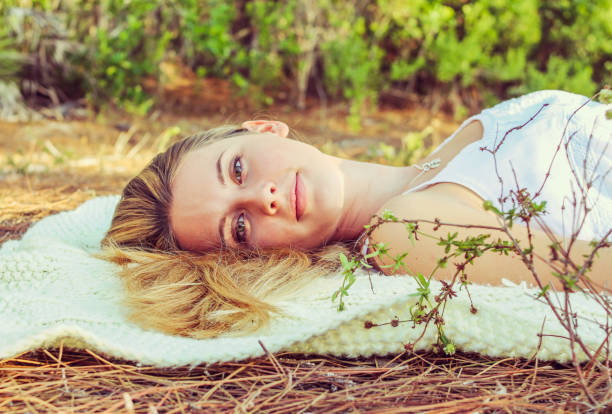 Beautiful young lady poses for the camera in nature. Beautiful blonde