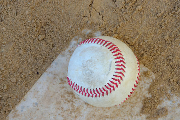 istock Well used baseball and glove on a baseball field 836044602
