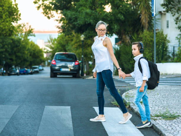 istock Son and Mom crossing the road 836051026