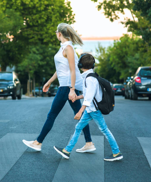 istock Son and Mom crossing the road 836051036