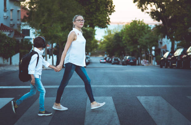istock Son and Mom crossing the road 836051042