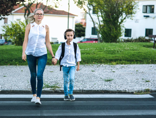 istock Son and Mom crossing the road 836051046