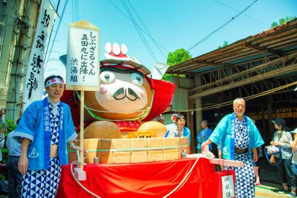 Crowds of japanese people carrying a Mikoshi during the National Foundation Day Celebration Parade on February 11 to commemorate the founding of Japan  and the ascension of Emperor Jimmu to the throne in 660 B.C, Tokyo, Japan.