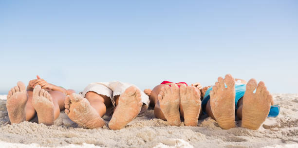 istock Feet of friends lying together 836069700
