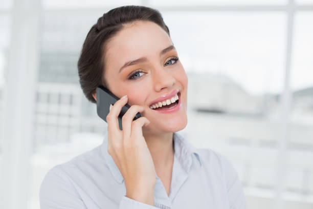istock Cheerful elegant young businesswoman using cellphone 836070058