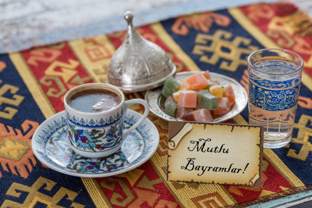 istock Happy eid text in turkish on greeting card with turkish coffee, delights on traditional tablecloth 836073716