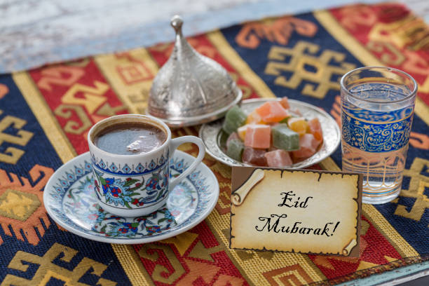 istock Eid mubarak text  on greeting card with turkish coffee, delights on traditional tablecloth 836073916