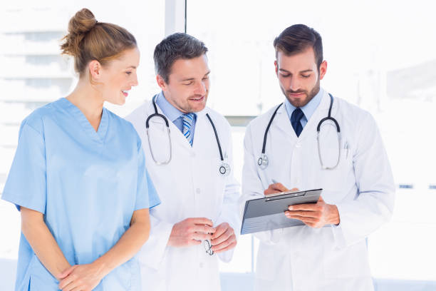 istock Doctors and female surgeon reading medical reports 836076898