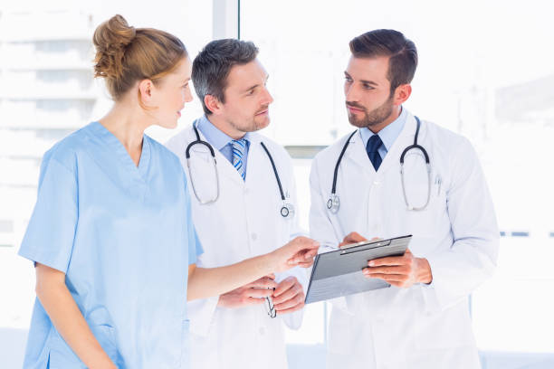 istock Doctors and female surgeon reading medical reports 836076932