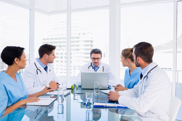 istock Concentrated medical team around desk 836077050