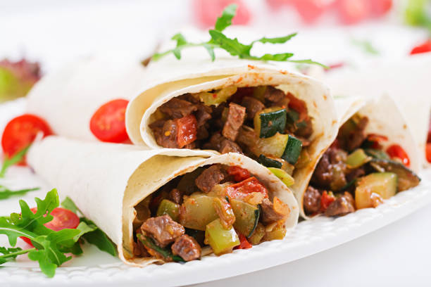 istock Burritos wraps with beef and vegetables on a light  background. 836077062